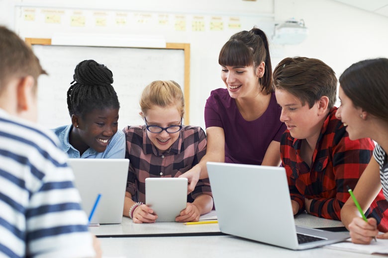 A group of children of different races doing schoolwork.
